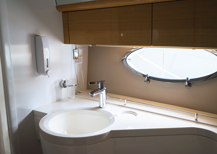 Sink and silver faucet in the luxury yacht.
